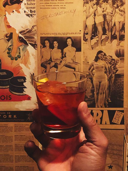 Negroni cocktail with old photos in the background