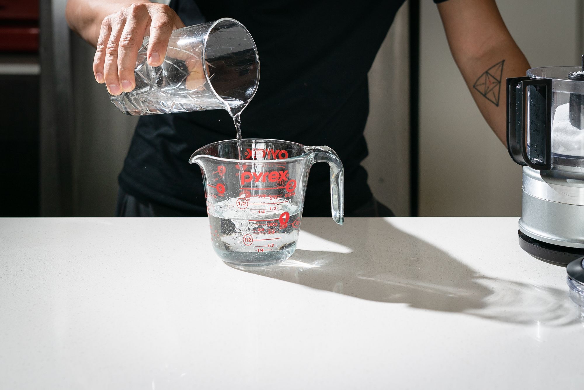adding water to measuring cup